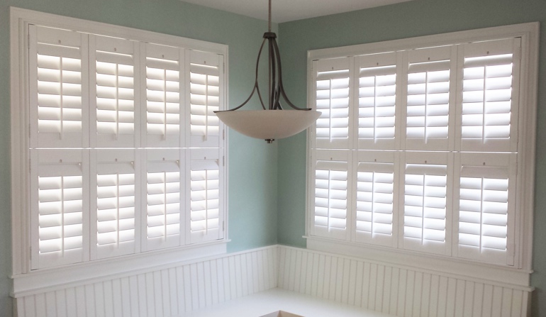 Soft green wall in San Antonio kitchen with shutters.